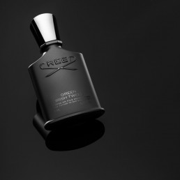 Product photography of Creed Green Irish Tweed Bottle on Gloss Black